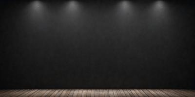 The primary subject of the image is a black wall with a wooden floor. The setting is a dark room, and the visual style is a photo. The dominant colors are black and brown, creating a moody atmosphere.