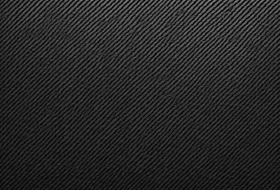 The primary subject of the image is a black background with a pattern of black and white squares. The setting is a dark room, and the visual style is a black and white photo. The dominant colors are black and white, creating a moody and dramatic atmosphere.