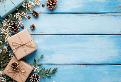 The primary subject of the image is a wooden table with a blue surface. On the table, there are three wrapped presents, each with a bow. The setting is a cozy and warm environment, likely a home or a festive gathering. The visual style is a photo, capturing the details of the presents and the wooden table. The colors and mood of the image are predominantly blue, creating a sense of calmness and tranquility.