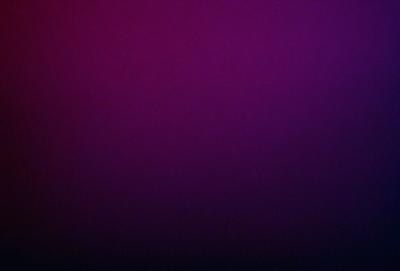 The primary subject of the image is a purple background. The setting is a dark, purple room with a red wall. The visual style is a close-up of the purple wall, creating a moody atmosphere. The colors and mood of the image are predominantly purple and dark, with a hint of red from the red wall.