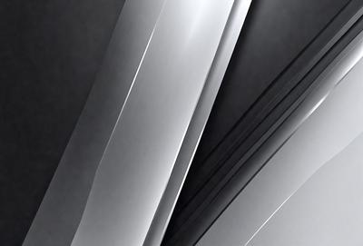 The primary subject of the image is a silver metal surface. The setting is a black background, which contrasts with the silver metal. The visual style is a close-up of the metal surface, showcasing its texture and reflective properties. The colors and mood of the image are predominantly black and silver, creating a sleek and modern atmosphere.