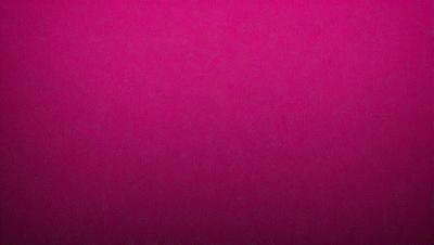 The primary subject of the image is a large, pink wall. The setting is a room with a pink background, and the visual style is a close-up of the wall. The dominant colors in the image are pink, and the overall atmosphere is bright and vibrant.