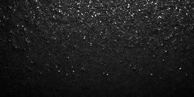 The primary subject of the image is a black background with a pattern of glittering silver stars. The setting is a dark, starry night, and the visual style is a combination of a photo and digital art. The colors and mood are predominantly dark and mysterious, with the silver stars adding a touch of brightness and intrigue to the scene.