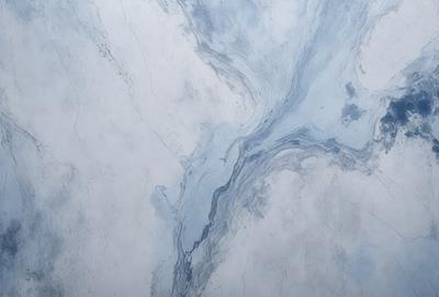 The primary subject of the image is a marble countertop with a blue and white pattern. The setting is a kitchen or bathroom environment, with the countertop being the main focus. The visual style is a photo, capturing the natural beauty of the marble countertop. The colors and mood of the image are predominantly blue and white, creating a clean and elegant atmosphere.