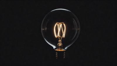 The primary subject of the image is a light bulb, which is the main object in the scene. The light bulb is illuminated, creating a warm and inviting atmosphere. The setting is a dark background, which contrasts with the light bulb, emphasizing its brightness. The visual style of the image is a close-up of the light bulb, showcasing its intricate details. The colors and mood of the image are predominantly warm and cozy, with the light bulb being the foc