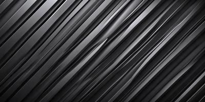 The primary subject of the image is a close-up of a black and silver metal surface. The setting is a dark room, and the visual style appears to be a photo. The dominant colors are black and silver, creating a sleek and modern atmosphere.