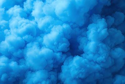 The primary subject of the image is a cloudy blue sky filled with clouds. The setting is an outdoor environment, with the sky serving as the backdrop. The visual style is a photo, capturing the beauty of the cloudy sky. The dominant colors are blue and white, creating a serene and calming atmosphere.