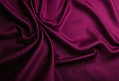 The primary subject of the image is a purple fabric, which is the main object, scene, or focus of the image. The setting or background is a purple cloth, and the visual style is a close-up of the fabric. The colors and mood of the image are predominantly purple, creating a calm and serene atmosphere.