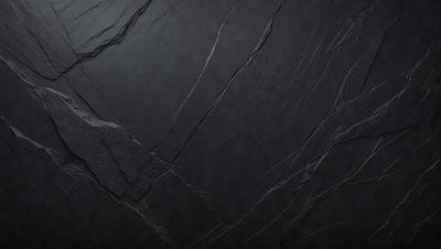 The primary subject of the image is a black marble countertop. The setting is a dark room, and the visual style is a close-up of the marble countertop. The countertop appears to be a dark grey color, giving it a sophisticated and elegant appearance.