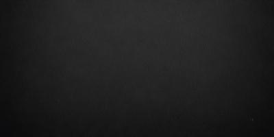 The primary subject of the image is a black background. The setting is a dark room, and the visual style is a black and white photo. The colors and mood of the image are dark and moody, creating a sense of mystery or drama.