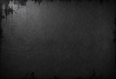 The primary subject of the image is a black background with a leather texture. The setting is a dark room, and the visual style is a close-up of the leather texture. The colors and mood of the image are predominantly dark and moody, with the black background and leather texture creating a dramatic and intense atmosphere.