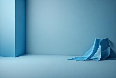 The primary subject of the image is a blue piece of paper or a blue object, which is placed on a blue surface. The setting appears to be a room with a blue wall, and the visual style is a close-up of the blue object. The colors and mood of the image are predominantly blue, creating a calm and serene atmosphere.