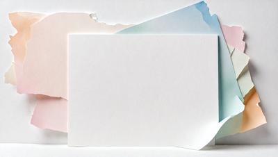 The primary subject of the image is a white piece of paper. The setting is a table, and the visual style is a photo. The colors and mood of the image are predominantly white, giving it a clean and minimalist appearance.
