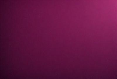 The primary subject of the image is a large, purple wall. The setting is a room with a pink background. The visual style is a close-up of the wall, showcasing its color and texture. The dominant colors are purple and pink, creating a warm and inviting atmosphere.