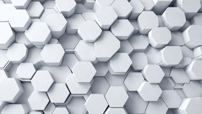 The primary subject of the image is a large white wall with a pattern of white hexagons. The setting is a white room, and the visual style is a close-up of the hexagonal pattern. The dominant colors are white, and the overall atmosphere is clean and minimalistic.