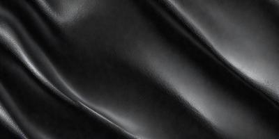 The primary subject of the image is a close-up of a black leather surface. The setting is a dark room, and the visual style appears to be a photo. The dominant colors are black and grey, creating a moody atmosphere.