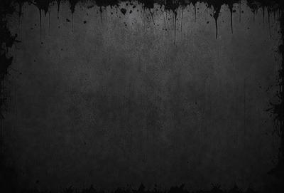 The primary subject of the image is a black and white photo of a wall. The setting is a room with a black background, and the visual style is a close-up of the wall. The colors and mood of the image are predominantly dark and moody, with the black and white color scheme adding to the atmosphere.