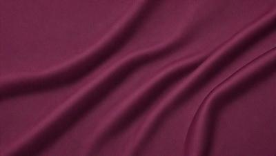 The primary subject of the image is a piece of red fabric, which is the main object, scene, or focus of the image. The setting or background of the image is a red cloth, which is the environment, backdrop, or surface visible in the image. The visual style of the image is a close-up of the red fabric, which suggests that it is a photo or a digital art piece. The dominant colors in the image are red, which creates a warm and vibrant atmosphere.