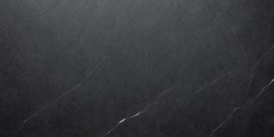 The primary subject of the image is a black marble countertop. The setting is a room with a black background, which creates a dramatic contrast with the marble countertop. The visual style is a close-up of the marble countertop, showcasing its texture and details. The colors and mood of the image are dark and moody, emphasizing the elegance and sophistication of the marble countertop.