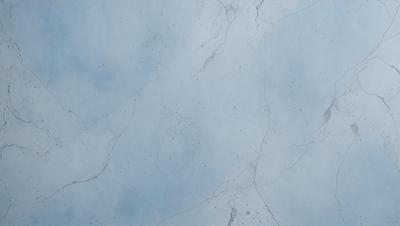 The primary subject of the image is a blue marble wall with a white and blue pattern. The setting is a room with a blue and white marble wall. The visual style is a photo of the marble wall. The colors and mood of the image are predominantly blue and white, creating a calm and serene atmosphere.