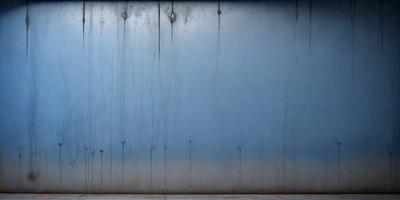 The primary subject of the image is a blue wall with a pattern of dripping water. The setting is a room with a blue wall, and the visual style is a photo. The colors and mood of the image are predominantly blue, creating a calm and serene atmosphere.