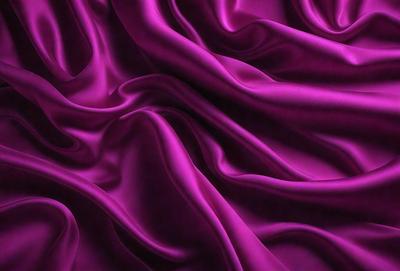The primary subject of the image is a purple fabric, which is the main object, scene, or focus of the image. The setting or background is a purple curtain, and the visual style is a close-up of the purple fabric. The colors and mood of the image are predominantly purple, creating a calm and serene atmosphere.