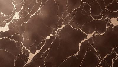 The primary subject of the image is a marble wall with a brown and gold color scheme. The setting is a room with a brown and gold marble wall, which serves as the background. The visual style is a close-up of the marble wall, showcasing its intricate patterns and textures. The colors and mood of the image are warm and luxurious, evoking a sense of sophistication and elegance.