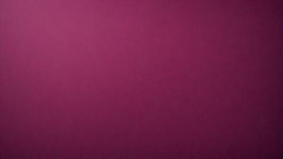 The primary subject of the image is a large, pink wall. The setting is a room with a pink background, and the visual style is a close-up of the wall. The dominant colors in the image are pink, and the overall atmosphere is warm and inviting.