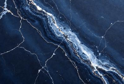 The primary subject of the image is a blue and gold marbled wall. The setting is a dark room with a blue background. The visual style is a close-up of the marbled wall, showcasing its intricate patterns. The colors and mood of the image are dark and moody, with the blue and gold marbled wall creating a striking contrast against the dark background.