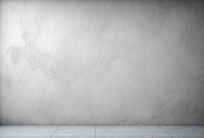 The primary subject of the image is a white wall with a large crack in it. The setting is a room with a concrete floor. The visual style is a photo, and the colors and mood are predominantly white, giving the image a clean and minimalist appearance.
