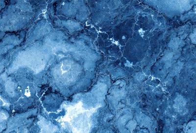 The primary subject of the image is a blue marble surface with a pattern of white spots. The setting is a close-up of the marble, showcasing its unique texture and design. The visual style is a close-up of the marble, emphasizing its intricate details. The colors and mood of the image are predominantly blue and white, creating a sense of calmness and elegance.
