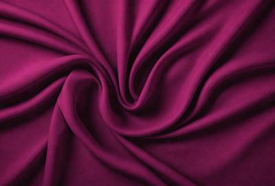 The primary subject of the image is a purple fabric, which is the main object, scene, or focus of the image. The setting is a close-up view of the fabric, showcasing its texture and pattern. The visual style is a photo, capturing the purple fabric in detail. The colors and mood of the image are predominantly purple, creating a calm and soothing atmosphere.