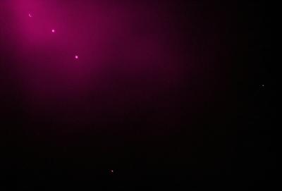 The image is a black and white photo of a purple sky. The sky is filled with a few stars, creating a sense of depth and contrast. The overall atmosphere is serene and artistic, with the purple hue adding a touch of mystery to the scene.