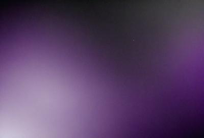 The primary subject of the image is a purple sky, which creates a unique and striking visual effect. The setting is a dark, cloudy sky, with no visible landmarks or objects. The visual style of the image is a combination of a photo and digital art, as it appears to be a manipulated or edited photograph. The colors and mood of the image are predominantly purple, giving it a moody and atmospheric feel.