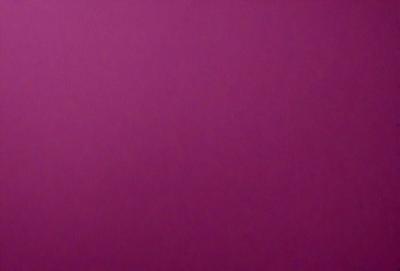 The primary subject of the image is a large, purple wall. The setting is a room with a pink background. The visual style is a close-up of the wall, which gives a sense of depth and texture. The dominant colors are purple and pink, creating a warm and inviting atmosphere.