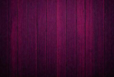 The primary subject of the image is a wooden wall with a purple color. The setting is a room with a wooden surface, and the visual style is a close-up of the wooden wall. The dominant colors are purple and brown, creating a warm and cozy atmosphere.