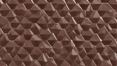 The primary subject of the image is a patterned wall made of brown and white tiles. The setting is a room with a brown and white tile wall as the main focus. The visual style is a close-up of the tiled wall, showcasing the intricate pattern. The colors and mood of the image are warm and inviting, with the brown and white tiles creating a cozy atmosphere.