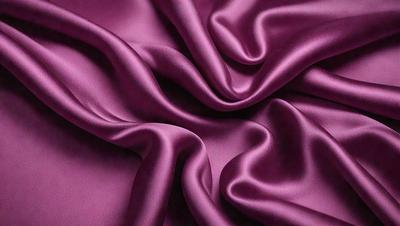 The primary subject of the image is a purple fabric, which is the main object, scene, or focus of the image. The setting or background is a purple sheet, and the visual style is a close-up of the fabric. The colors and mood of the image are predominantly purple, creating a calm and soothing atmosphere.