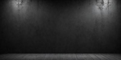 The primary subject of the image is a black wall with a grey texture. The setting is a room with a wooden floor. The visual style is a photo, and the dominant colors are black and grey. The overall atmosphere is dark and moody.