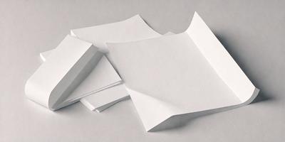 The primary subject of the image is a stack of white paper. The setting is a table, and the visual style is a photo. The colors and mood of the image are predominantly white, giving it a clean and minimalist appearance.