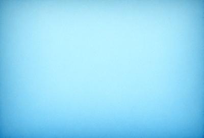 The primary subject of the image is a large, empty blue sky. The setting is a vast, open space with no visible landmarks or objects. The visual style is a natural, outdoor environment. The colors and mood are predominantly blue, creating a calm and serene atmosphere.