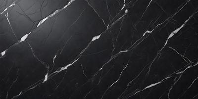 The primary subject of the image is a black marble countertop. The setting is a kitchen, with the countertop being the main focus of the scene. The visual style is a close-up of the marble countertop, showcasing its texture and pattern. The colors and mood of the image are predominantly dark, with the black marble countertop being the main source of contrast.