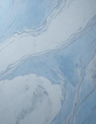 The primary subject of the image is a blue marble tile with a pattern of swirls and curves. The setting is a bathroom, as indicated by the presence of the blue marble tile. The visual style is a close-up of the tile, showcasing its intricate design. The colors and mood of the image are predominantly blue, creating a calm and soothing atmosphere.