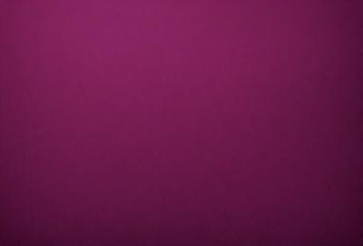 The primary subject of the image is a purple wall. The setting is a room with a purple wall, and the visual style is a close-up of the wall. The dominant colors are purple, and the overall atmosphere is calm and serene.