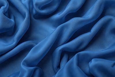 The primary subject of the image is a blue fabric, which is the main object, scene, or focus of the image. The setting or background is a blue cloth, and the visual style is a photo. The dominant colors and overall atmosphere are blue and serene.