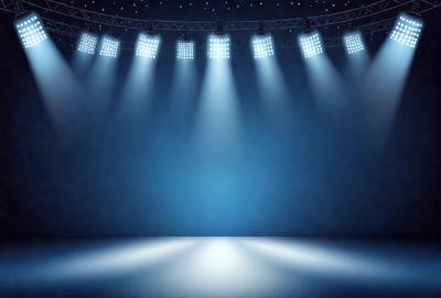 The primary subject of the image is a stage with a blue background. The stage is illuminated by bright lights, creating a dramatic and captivating atmosphere. The setting is a theater or a performance venue, and the visual style is a digital art or illustration. The colors and mood of the image are predominantly blue, creating a sense of calmness and sophistication.