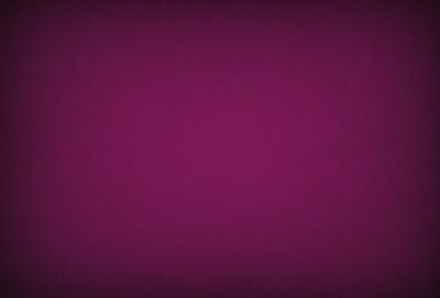The primary subject of the image is a purple background. The setting is a dark, purple room with a pinkish hue. The visual style is a close-up of the purple background, which gives the image a moody and dramatic appearance. The colors and mood of the image are predominantly purple and pink, creating a sense of depth and intensity.