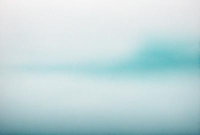 The primary subject of the image is a cloudy sky. The setting is a vast, open space with a blue hue. The visual style is a photo, capturing the beauty of the cloudy sky. The colors and mood convey a sense of tranquility and serenity.