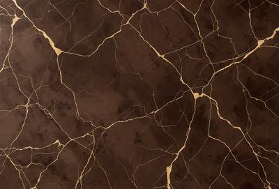 The primary subject of the image is a close-up of a marble wall with a brown and gold color scheme. The setting is a room with a brown and gold marble wall, which serves as the background. The visual style is a close-up of the marble wall, showcasing its texture and patterns. The colors and mood of the image are warm and luxurious, with the brown and gold tones creating a sense of sophistication and elegance.
