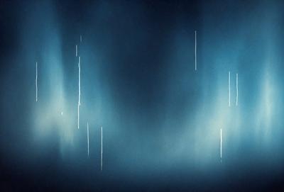 The primary subject of the image is a blue sky with a few white streaks. The setting is a cloudy sky, and the visual style appears to be a photo. The colors and mood of the image are predominantly blue and somewhat moody.